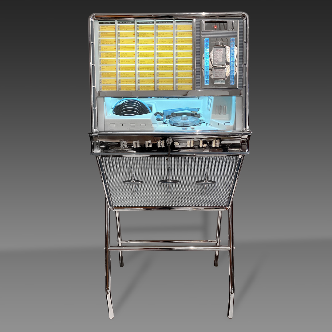 Rock-Ola Model 1484 from 1960 with space for 50 single records (100 copies). The jukebox is in exceptional condition, with newly chromed metal parts, overhauled mechanics, and working order. It has a fantastic sound!